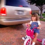child biking behind car